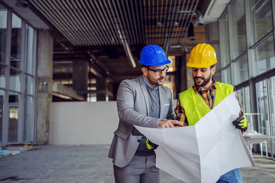 Engineers reviewing construction drawings on site